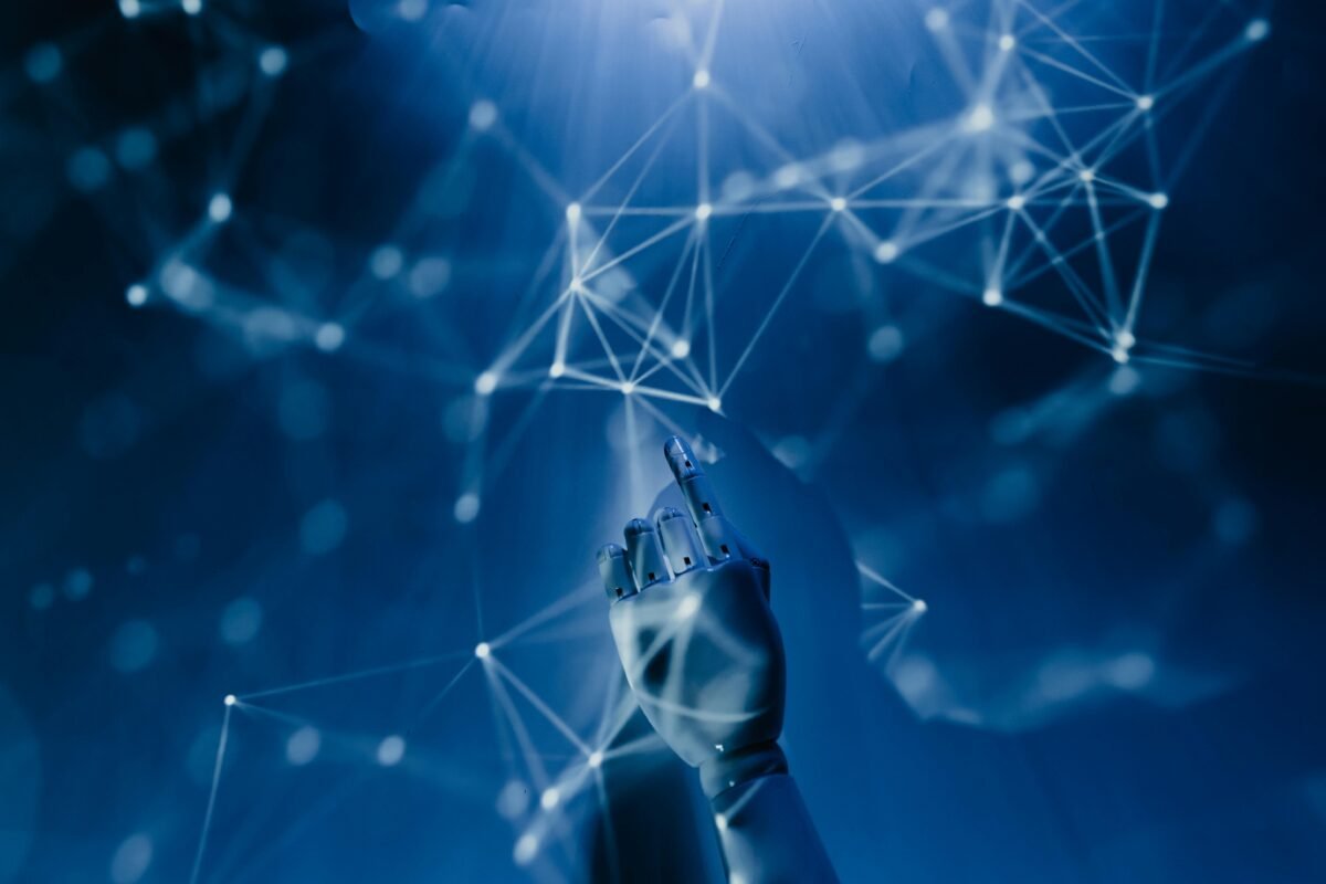 Robotic AI hand touching futuristic digital network connections on a blue technology background.