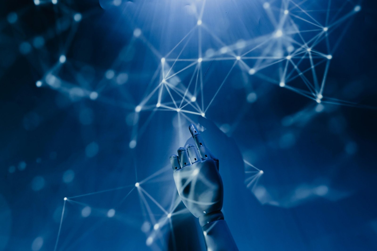 Robotic AI hand touching futuristic digital network connections on a blue technology background.